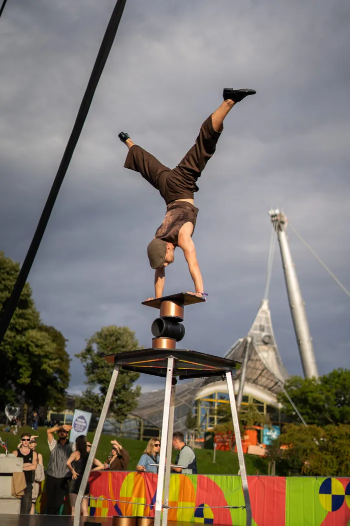 Misha performing an outdoor handstand above a high table